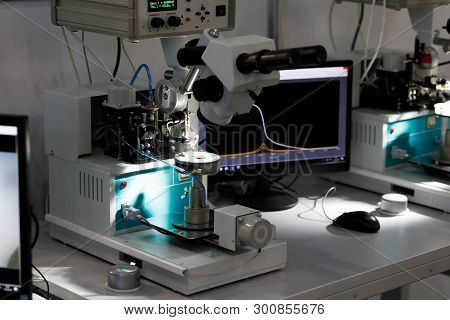 Manual Ultrasonic Wire Bonding Machines At Semiconductor Factory. Selective Focus.