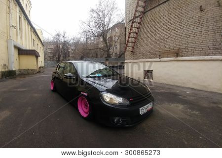 Moscow, Russia - May 08, 2019: A Black Tuned And Understated Volkswagen Golf 6 With Bright Pink Hand