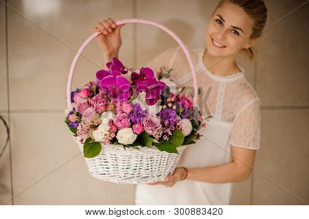 Basket With Differnet Flowers In Girls Hands