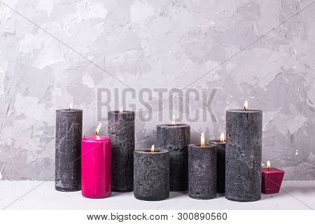 Black And Red  Burning Candles  On Grey Textured Background. Spa Or Still Life Concept. Selective Fo