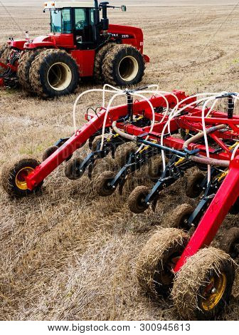 DECABRIST VILLAGE, SARATOV REGION, RUSSIA - 28 APRIL 2019: Sowing works on the wheat field. Planting complex - tractor and seeder mechanism