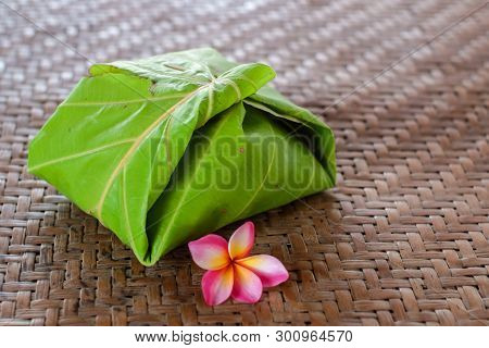 The Food Wrapping Up Made From Dipterocarpus Tuberculatus Roxb Leaf With Flower On The Bamboo Mat Ba