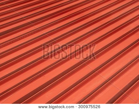 Red Painted H-beams On The Floor Forming A Linear, Diagonal Pattern.