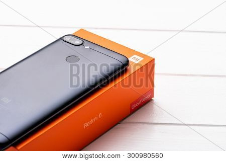Kharkiv, Ukraine - 02 Fabruary 2019: New Xiaomi Redmi 6 smartpphone on a wooden table