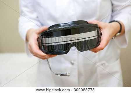 Doctor Coat Holding Glasses For Color-pulse Therapy, Close-up
