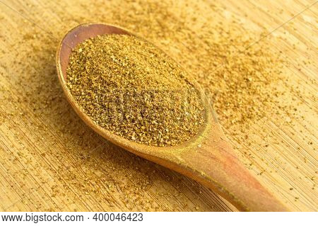 Aromatic Fragrant Organic Cumin Powder Spice, On Bamboo Cutting Board In Wooden Spoon