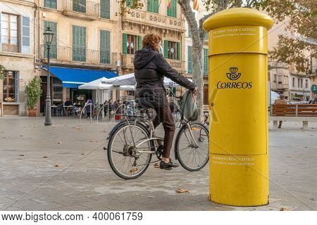 Llucmajor, Spain; December 17 2020: Yellow Mailbox Of The Spanish Postal Service. In The Background 