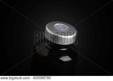 A Macro Shot With Selective Focus Of An Amber Color Vaccine Injection Bottle Set On A Dramatic Black