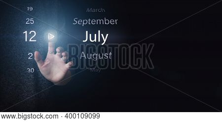 July 12nd. Day 12 Of Month, Calendar Date. Hand Click Luminous Icon Play And Date On Dark Blue Backg