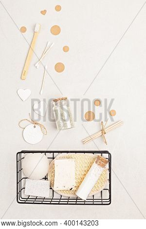 Eco Friendly Soap Bar, Tooth Brushes, Cotton Swabs, Bath Salt, Clay Mask And Washcloth On Neutral Ba