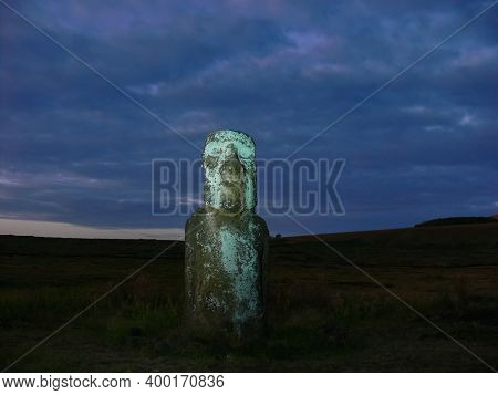Statues Of Easter Island In The Background Of The Sunset. The Melting Of The Easter Statue In The Su