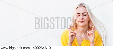 Woman Holding Fingers Crossed Isolated On White Background