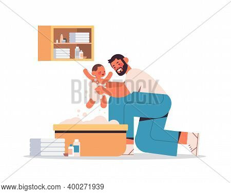 Young Father Bathing Little Son In Small Bath Tub Fatherhood Concept Dad Spending Time With His Kid 