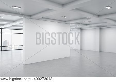 Bright Concrete Gallery Interior With City View, Daylight And Blank Wall. Museum And Art Concept. Mo