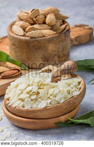 Raw  Almond Petals For Confectionery. Almond Nuts In Wooden Shovel, Almonds With Shell In Bamboo Bow