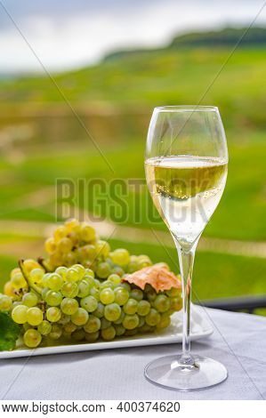 Tasting Of French Sparkling White Wine With Bubbles Champagne On Outdoor Terrace With View On Grand