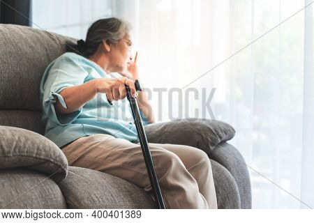 Close Up Images, Hand Of Asian Elderly Woman Which Holds The Cane To Support, Sitting Absent Lonely 