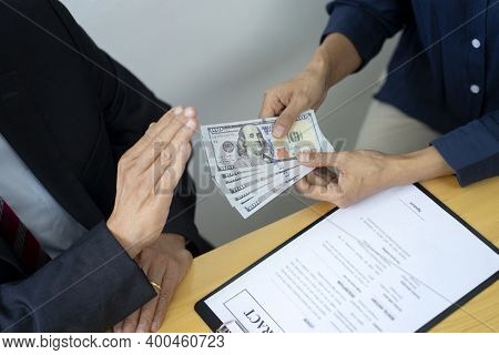Officer Hand Refusing To Take Bribe Cash Banknote From Businessman In The Concept Corruption