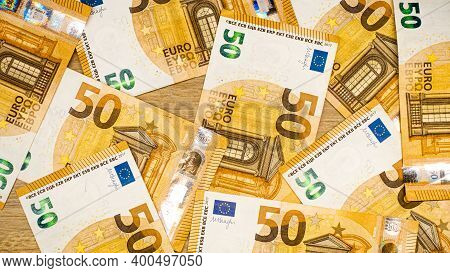 Euro Bills On A Wooden Table. Top View Of Fifty Euro Papers.