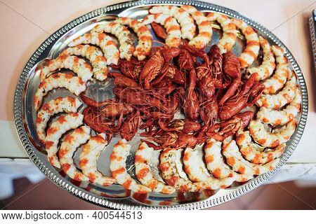 Festive Table With Ready Shrimps And Crayfishs With Seasoning On A Metal Tray On Banket