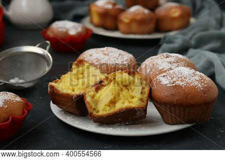 Homemade Muffins With Pineapple Pieces, Sprinkled With Powdered Sugar, Arranged On A Dark Background