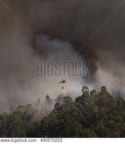 Portuguese Cs-hmi Civil Protection Firefighter Helicopter Dropping Water On A Forest Fire In Braga, 