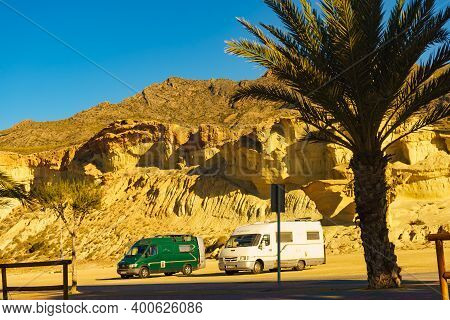 Bolnuevo, Spain - March 15, 2019: Camper Cars On Parking Area At Eroded Yellow Sandstone Formations,
