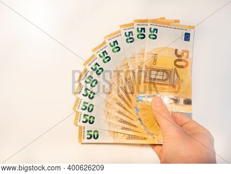A Man's Hand Holds A Fan Of Euro Banknotes. View From The Top.