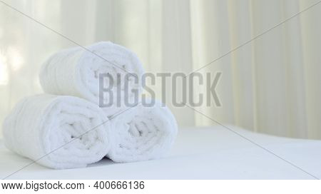 Close Up Oftowel Placed On Basket, White Table Top, Bottle Of Liquid Soap, Spa Set For Bathing In Th