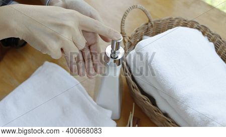 Towel Placed On Basket, White Table Top, Bottle Of Liquid Soap, Spa Set For Bathing In The Bathroom,