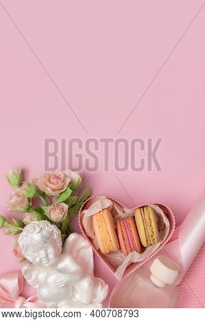 Valentine's Day Flat Lay With Gift Box, Macaroon, Flowers Bow, Angel On A Pink Background With Copy 