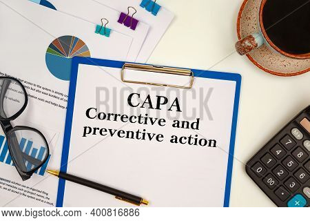 Paper With Corrective And Preventive Action Capa On The Table, Calculator And Glasses