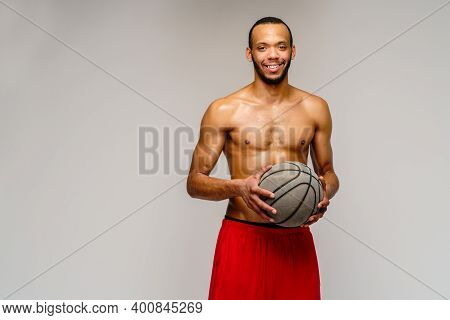 Muscular African American Sportsman Playing Basketball Shitless Over Light Grey Background