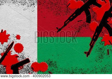 Madagascar Flag And Guns In Red Blood. Concept For Terror Attack And Military Operations