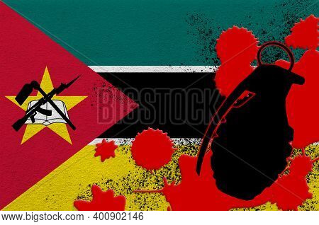 Mozambique Flag And Mk2 Frag Grenade In Red Blood. Concept For Terror Attack Or Military Operations 