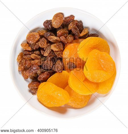 White Ceramic Bowl With Dried Golden Raisins And Dried Damascos Fruits Isolated On White, Top View. 