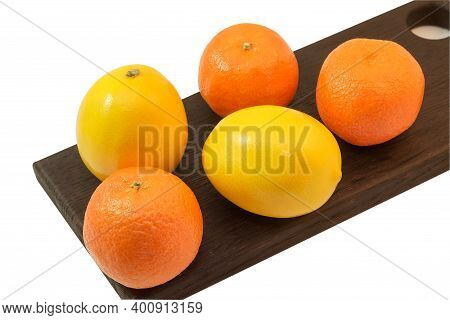 Yellow Fresh Lemons And Orange Tangerines On A Black Cutting Wooden Board, Isolate On A White Backgr