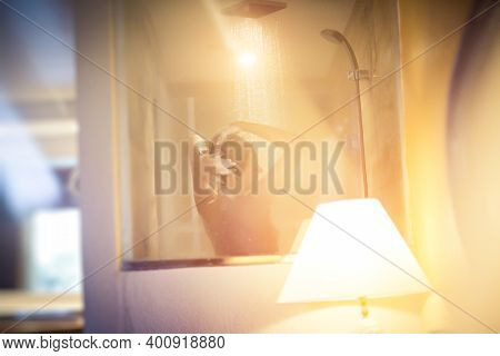 Soft Focus. Shooting Through Glass Woman Takes A Shower In A Hotel Room