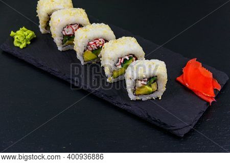 Uramaki Sushi Rolls With Surimi On A Black Slate