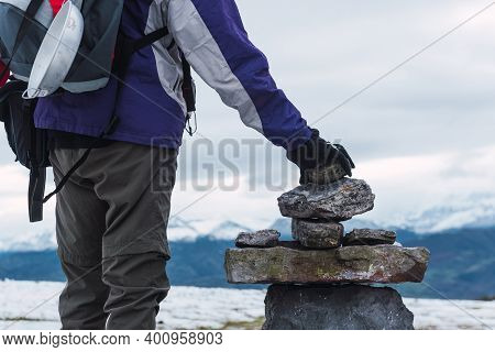 Unknown Mountaineer Places The Last Stone Of A Landmark To Signal The Way To Other Hikers. Trekking 