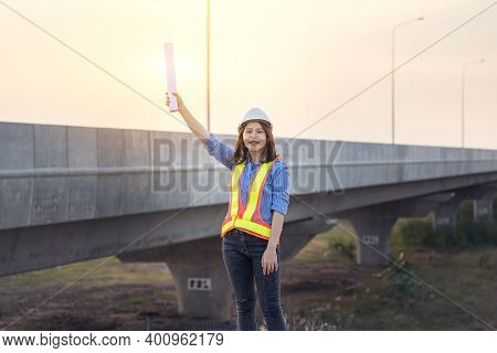 Beautiful Asian Female Engineer In White Safety Hard Hat Doing Job At Construction Site Outside Offi
