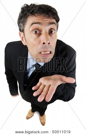 Needy business man begging, pleading his cause or showing his ignorance holding out the empty palm of his hand while looking expressively up at the camera isolated on white