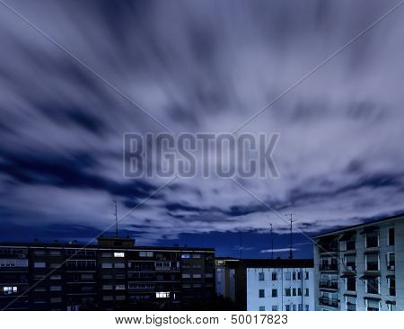 Quickening sky over city buildings