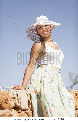 smiling young woman is on a sky background