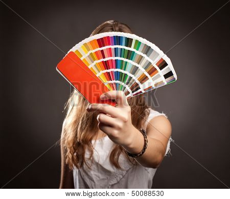 young woman holding a pantone palette