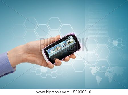 technology, internet, tv and news concept - woman hand with smartphone, videos and virtual screen