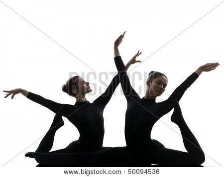 two women contortionist practicing gymnastic yoga in silhouette   on white background