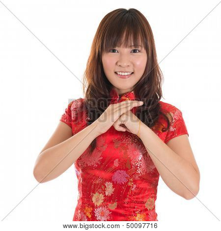 Asian woman with Chinese traditional dress cheongsam or qipao greeting. Chinese new year concept, female model isolated on white background.
