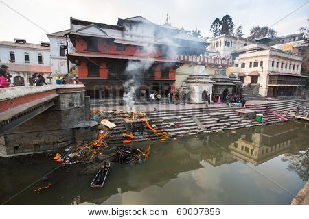 KATHMANDU, NEPAL - DEC 20: During the cremation ceremony along the holy Bagmati River in Bhasmeshvar Ghat at Pashupatinath temple, Dec 20, 2013 in Kathmandu, Nepal.