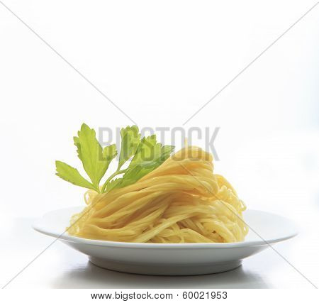 Chinese Yellow Eggs Noodle On White Disk With Green Leaves Of Celery Ready To Eating Meal On White B